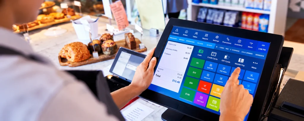 POS system touchscreen used by a café employee to process payments